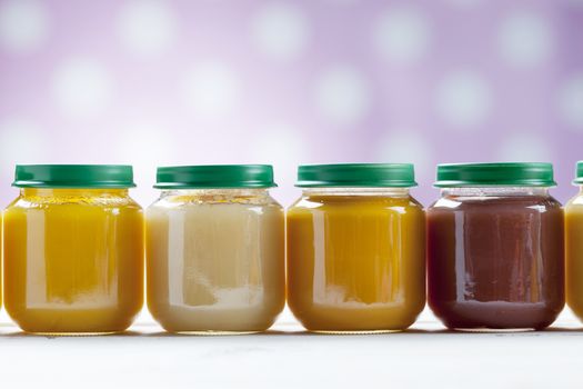 healthy ready-made baby food on a wooden table.