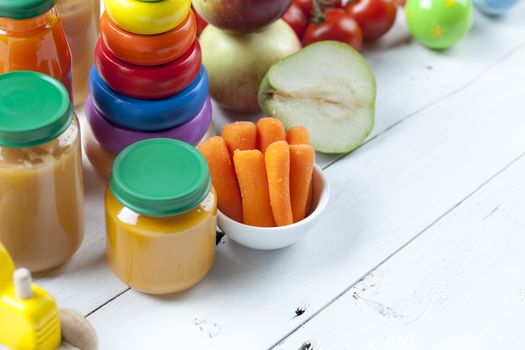 healthy ready-made baby food on a wooden table.