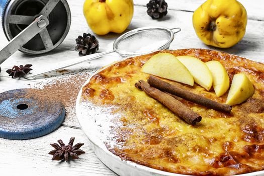 Homemade flour cake with quince and cooking utensils