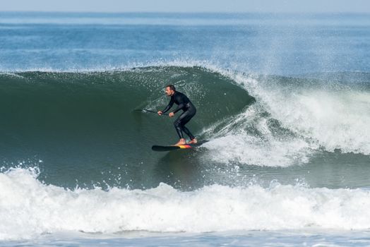 Stand up paddle surfer on the atlantic ocean.