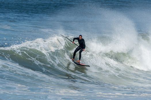 Stand up paddle surfer on the atlantic ocean.