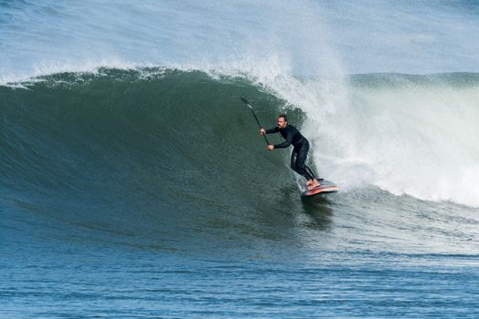 Stand up paddle surfer on the atlantic ocean.