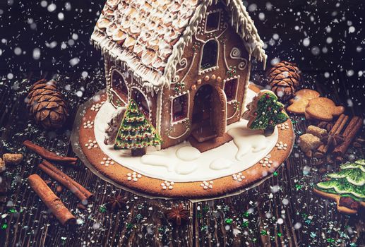 Homemade gingerbread house on dark background, xmas theme