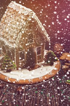 Homemade gingerbread house on dark background, xmas theme