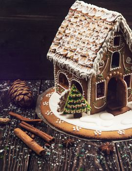 Homemade gingerbread house on dark background, xmas theme