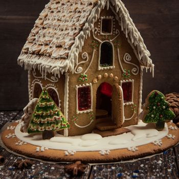 Homemade gingerbread house on dark background, xmas theme