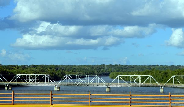 Metal bridge on stilts overlooking a river