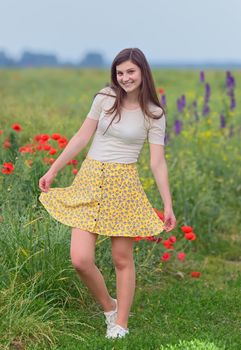 Smiling young girl on summer field