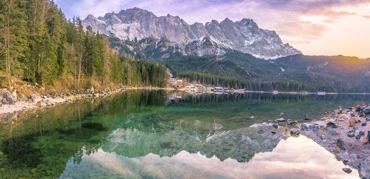 Alpine landscape with the German Alps mountains reflected in the Eibsee lake on a sunny day of December. Picture taken in Grainau, Germany.