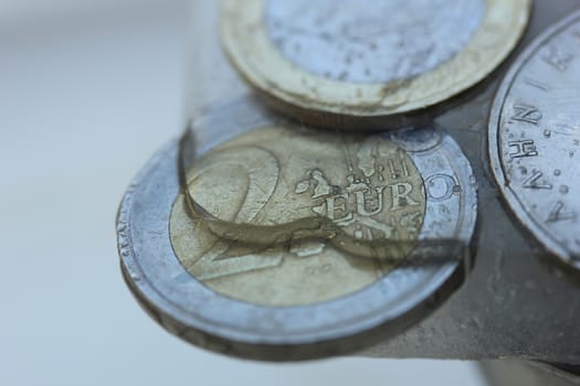 Two Euro coin in ice, frozen assets
