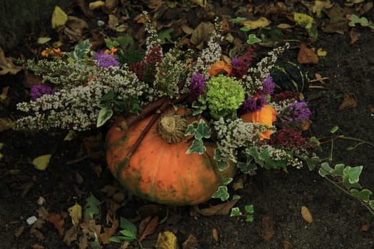 Decorated thanksgiving pumpkin with flowers and ivy