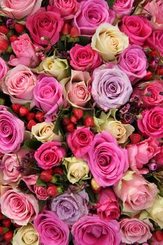 Various shades of pink roses in a wedding centerpiece