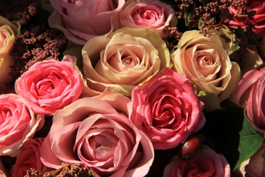 Pastel roses in different shades of pink in a bridal arrangement