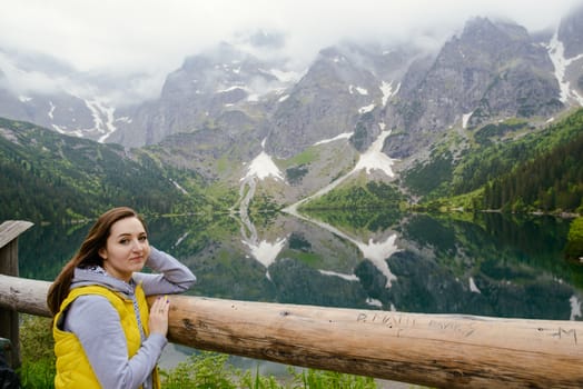 woman relaxing on the lake and mountains sunny landscape.