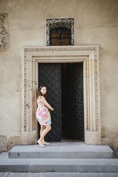 Beautiful girl during sightseeing old castle in Cracow, Wawel. Summer time