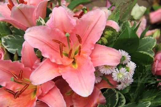 Pink tiger lilies and roses in a bridal arrangement