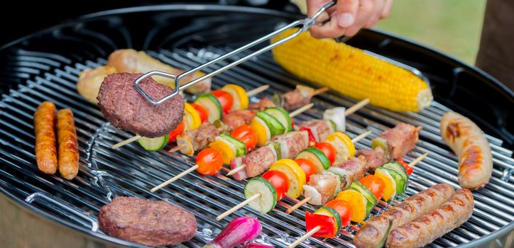 Service of meat on plate during a barbecue, France