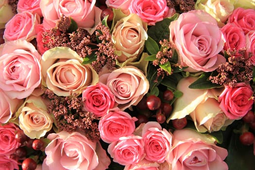Pastel roses in different shades of pink in a bridal arrangement