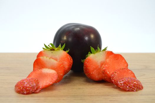 brown plum with strawberries sliced