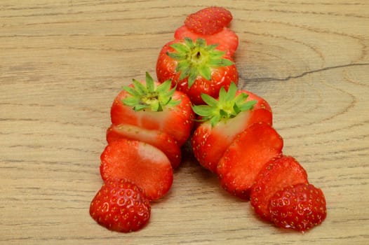 Strawberry trio cut into strips on a light wood background