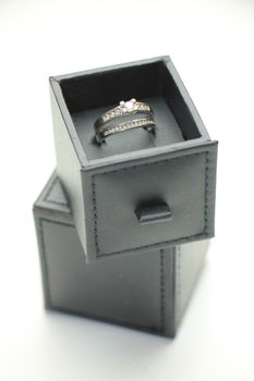 Diamond channel set engagement ring and wedding band in white gold in a luxurious ring box