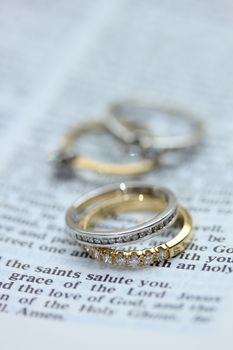 Two diamond wedding bands for a double bride wedding, on a bible verse