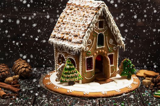 Homemade gingerbread house on dark background, xmas theme