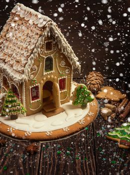 Homemade gingerbread house on dark background, xmas theme