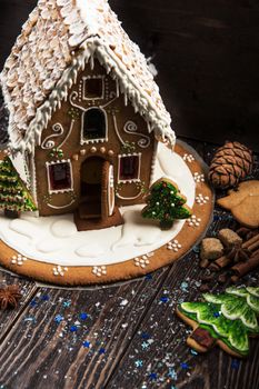 Homemade gingerbread house on dark background, xmas theme