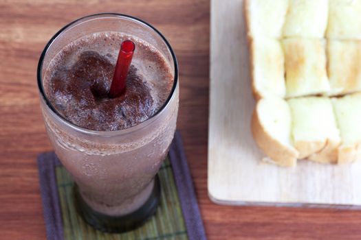 Cocoa chocolate smoothie in glass and Buttered bread and cup cake