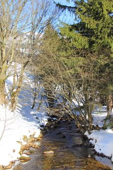 Winter landscape with forest and river in Spindleruv Mlyn, Krkonose, Czech Republic