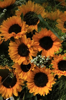 Big yellow sunflowers in a wedding floral arrangement