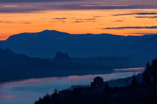 Sunrise over Vista House on Crown Point in Oregon and Beacon Rock in Washington State along Columbia River Gorge