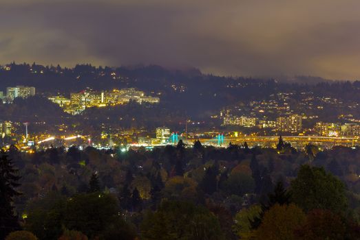 Marquam Hill Tilikum Crossing and Marquam Bridge in Portland Oregon during fall season one foggy night