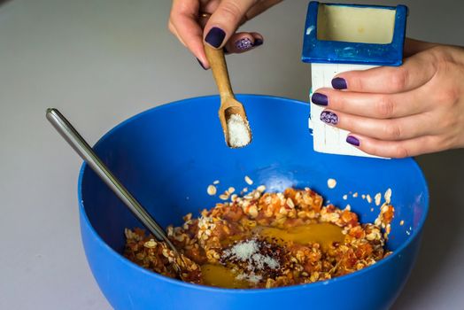 hand pour in salt from wooden spoons in stuffing