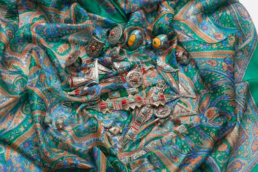 Handmade jewelry on fabric bacground in ethnic style