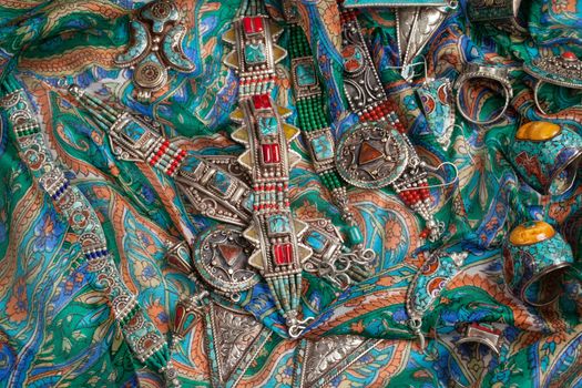 Handmade jewelry on fabric bacground in ethnic style