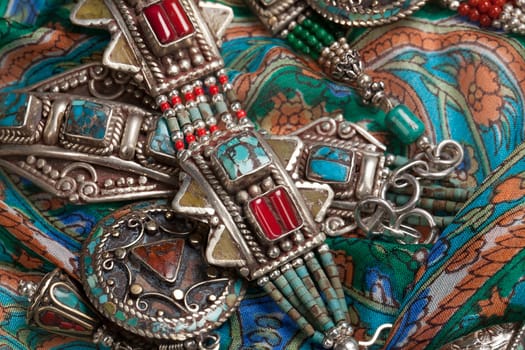 Handmade jewelry on fabric bacground in ethnic style
