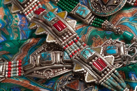Handmade jewelry on fabric bacground in ethnic style