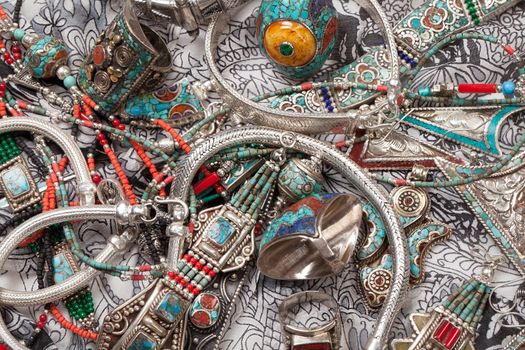 Handmade jewelry on fabric bacground in ethnic style
