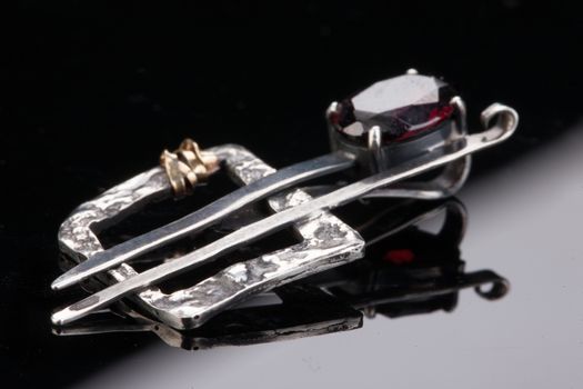 Handmade jewelry on a black glass studio background