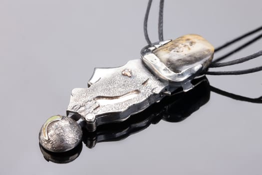 Handmade jewelry on a black glass studio background