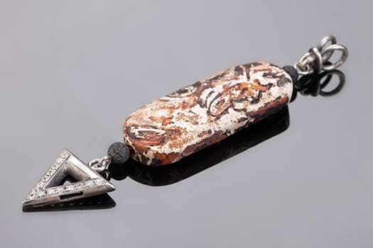 Handmade jewelry on a black glass studio background