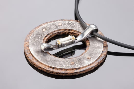Handmade jewelry on a black glass studio background