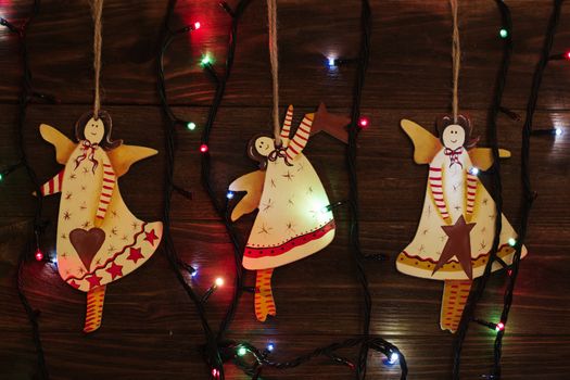 Christmas tree toys, angel. christmas decoration handmade toy Angel. christmas decoration handmade toys hanging over rustic wooden background.