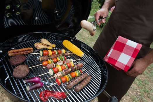 Assorted delicious grilled meat with vegetable over the coals on a barbecue