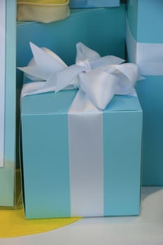 White satin bow on blue giftbox