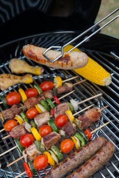 Assorted delicious grilled meat with vegetable over the coals on a barbecue