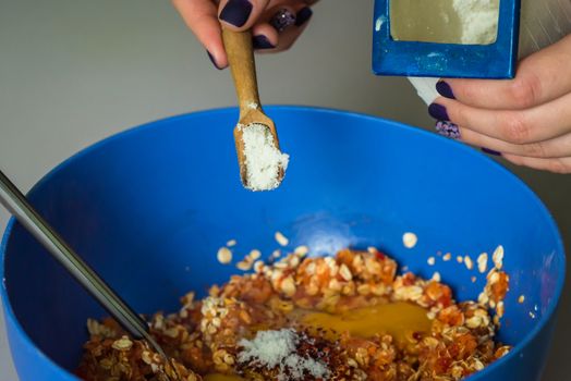 hand pour in salt from wooden spoons in stuffing