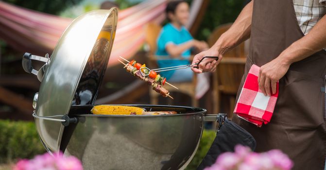 Assorted delicious grilled meat with vegetable over the coals on a barbecue